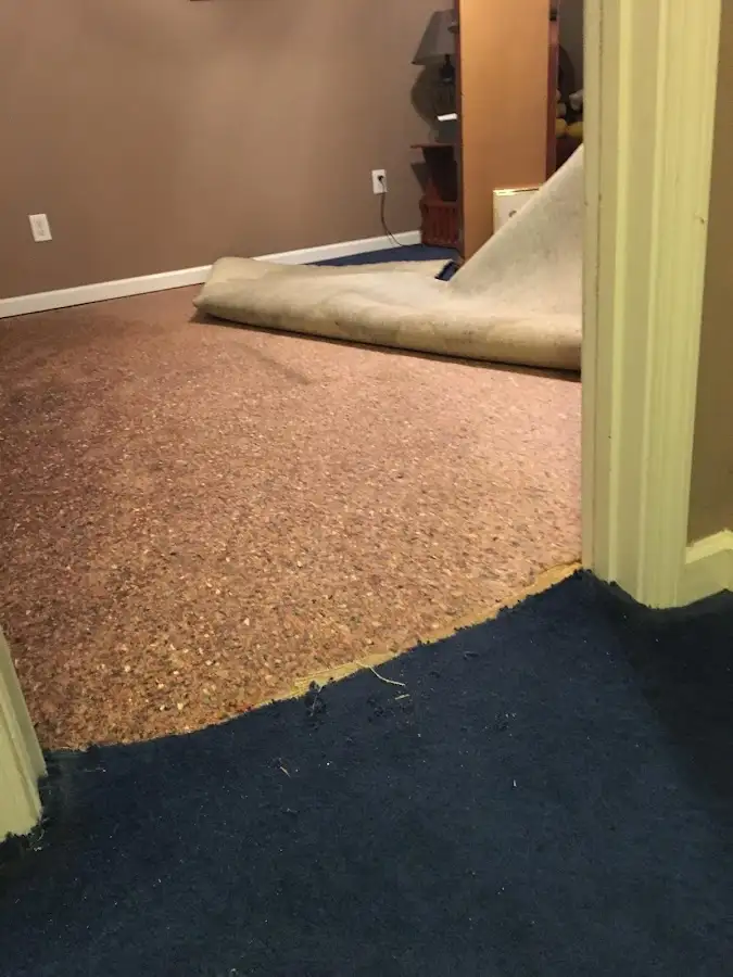 Carpet pad removal revealing water damage during Drying & Dehumidification in McCook
