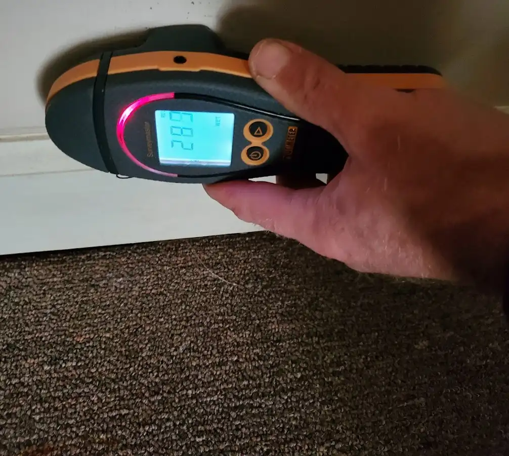 Moisture detection at baseboard during Storm Damage Restoration in McCook